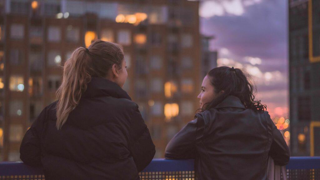 Two ladies on a rooftop in the city
