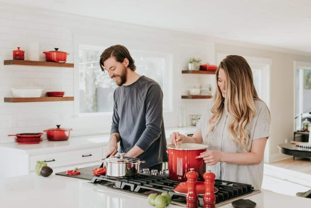 man and woman in cooking in a kitchen