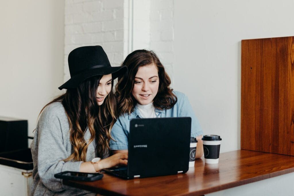 two girls looking at the laptop
