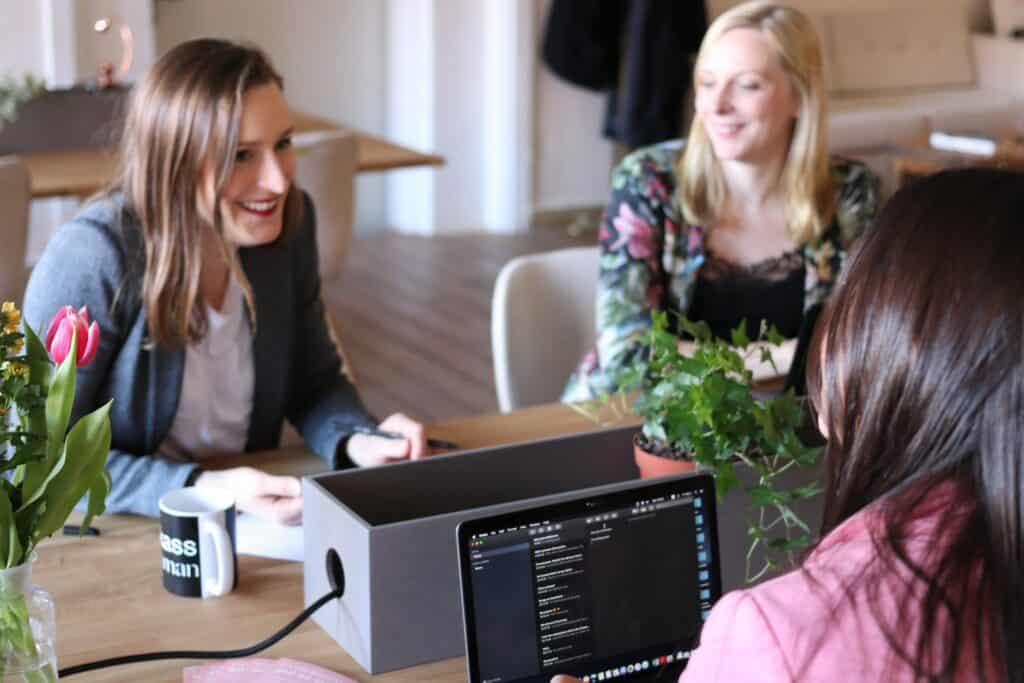 three girls working and talking together