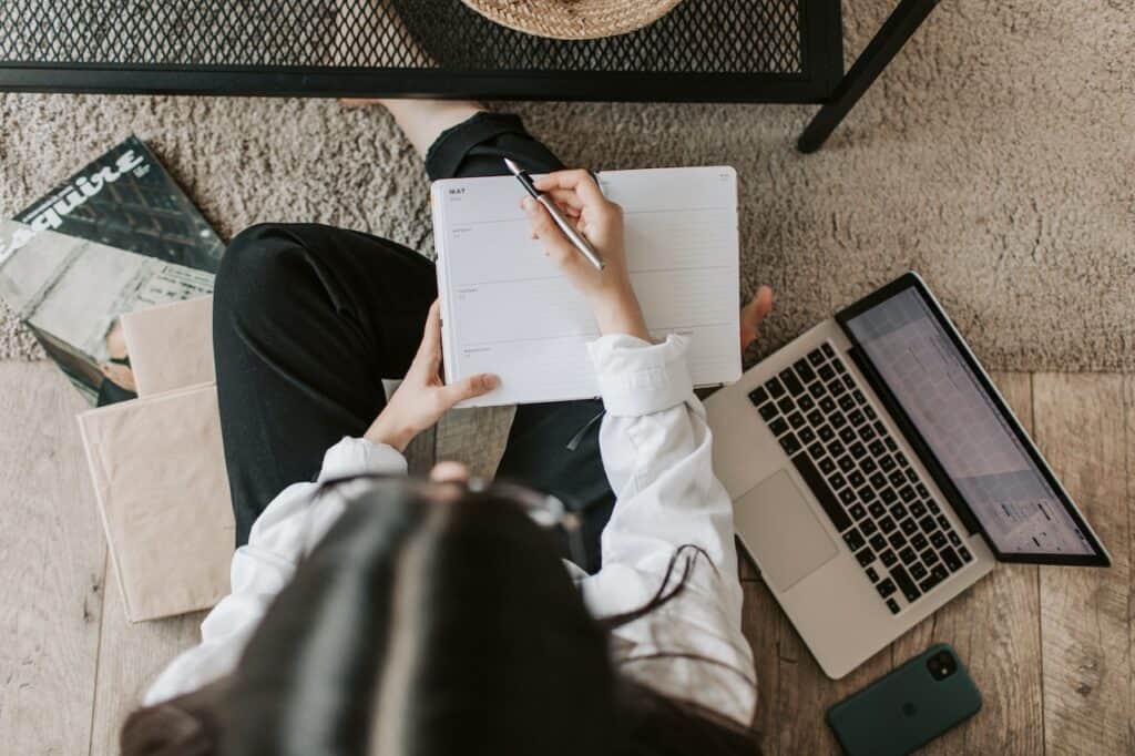 a woman sitting on the floor researching