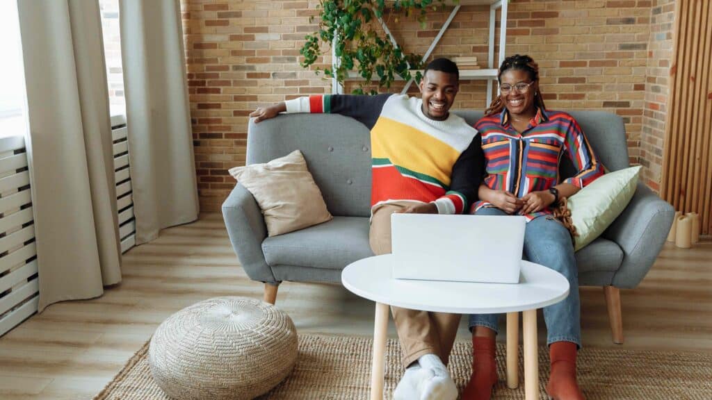 Boy and Girl Laughing in Their Home on the Sofa