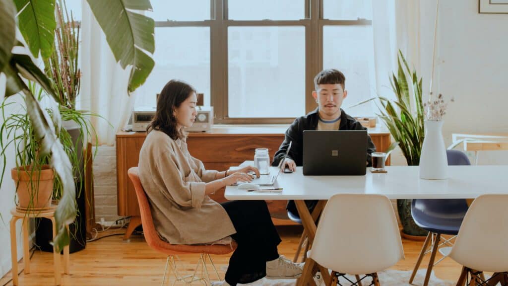 Boy and Girl Working From Home behind Laptop