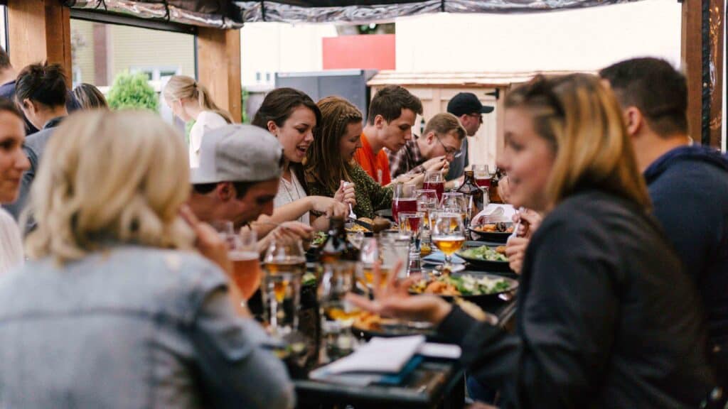 Happy People Enjoying Dinner Together on a City Rooftop