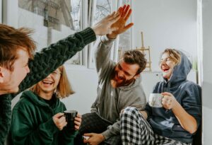 High Five Moment With Friends in Their Apartment