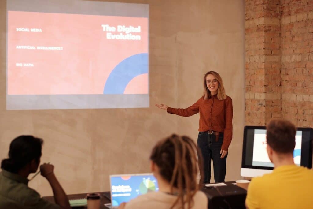 woman conducting a seminar with three individuals in the foreground