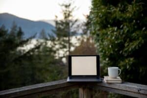 laptop coffee books with nature background