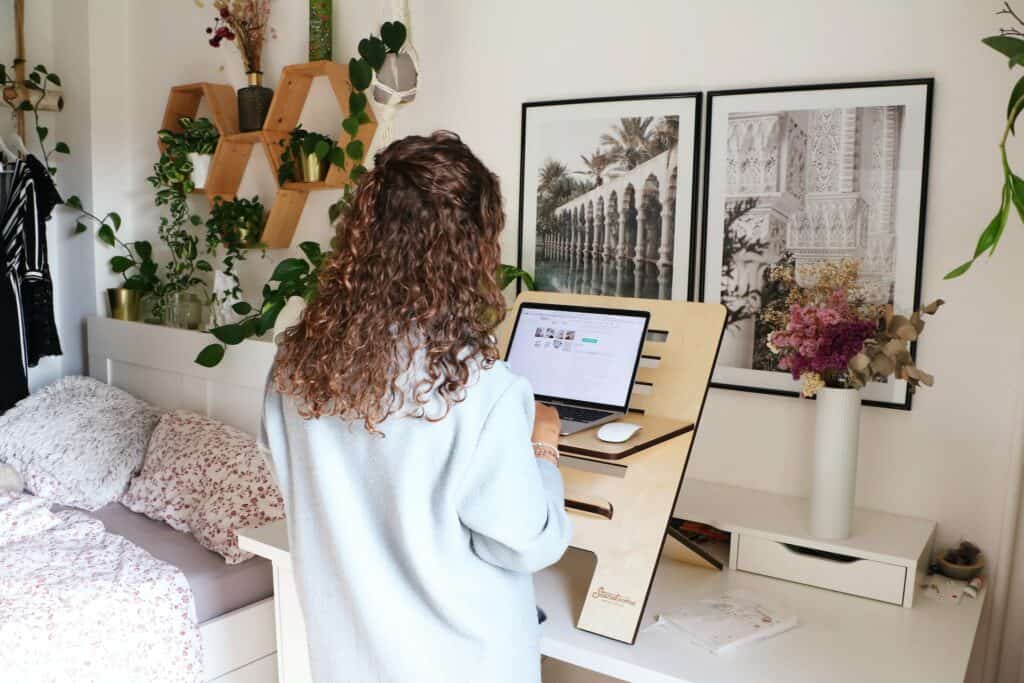 A girl working on her laptop in her room