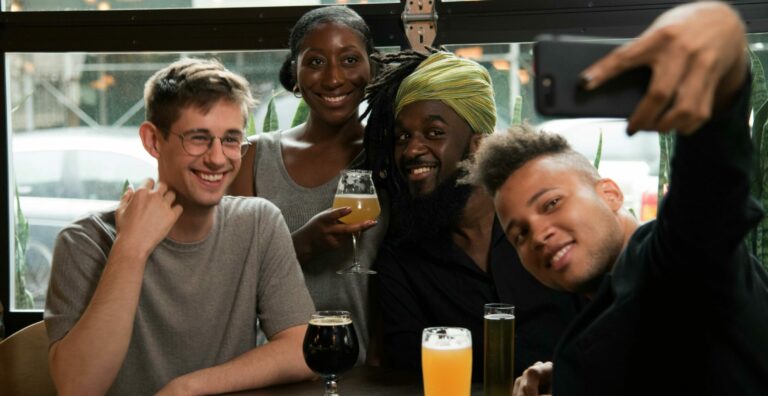 A group of people sharing a drink and taking a picture together.