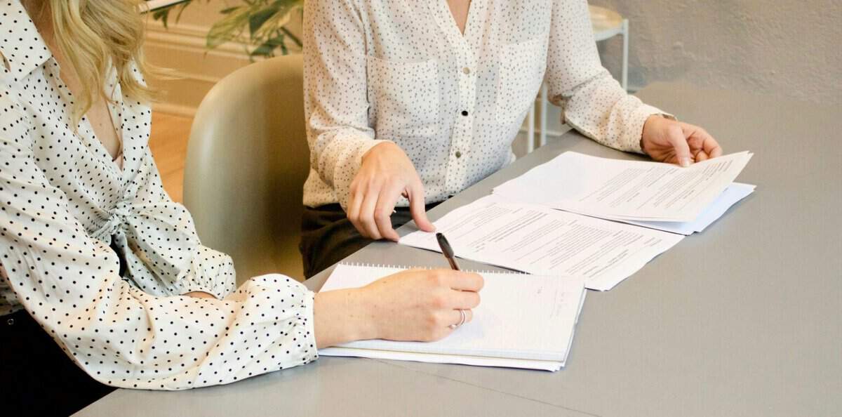 Signing legal papers in an office.