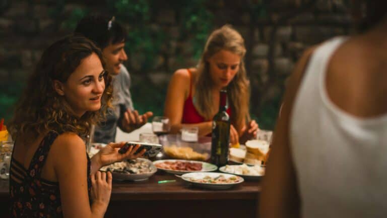 Friends having dinner outside by evening