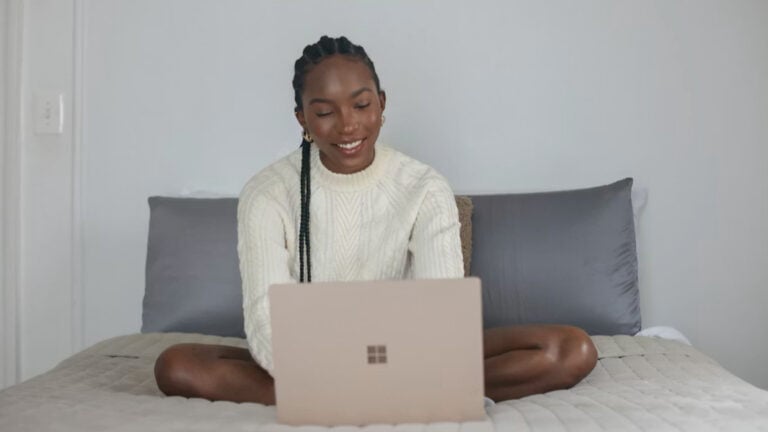 Smiling girl behind laptop