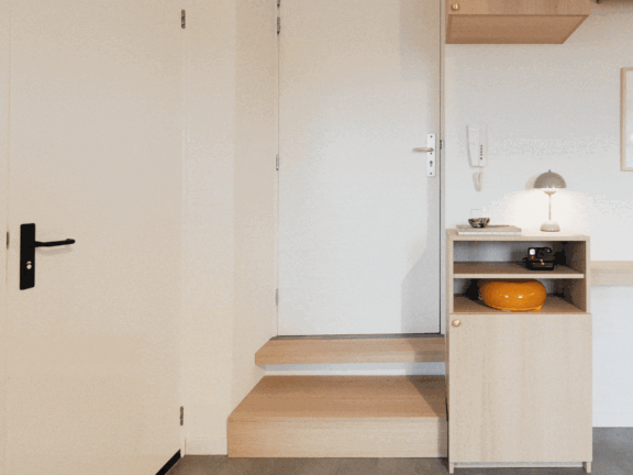 Animated entryway showing hidden storage units sliding and transforming within a light wood interior.