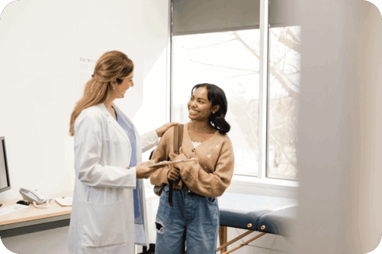 Woman speaking with a female doctor inside a medical consultation room