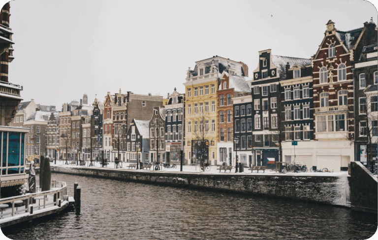 Snowy canal houses in Amsterdam, Netherlands, a potential remote work hub