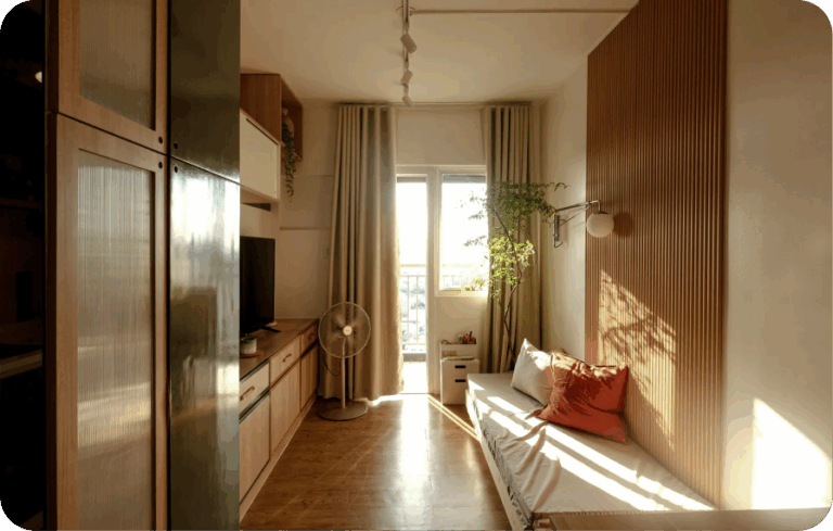 Compact sunlit studio apartment with minimal decor and wooden accents