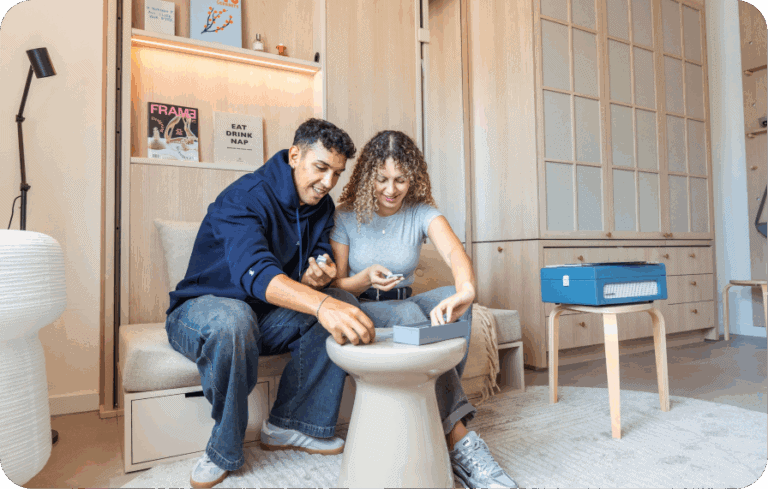 Couple playing a game together in a cozy, minimalist apartment