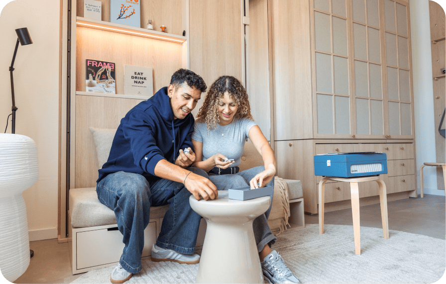 Couple playing a game together in a cozy, minimalist apartment